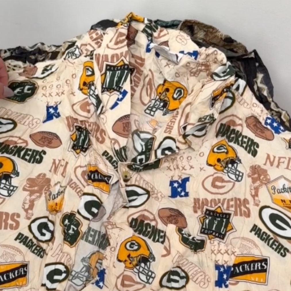 Unboxing a 45kg wholesale bale of vintage rayon shirts for men, featuring printed short and long sleeve styles in assorted colours and patterns.