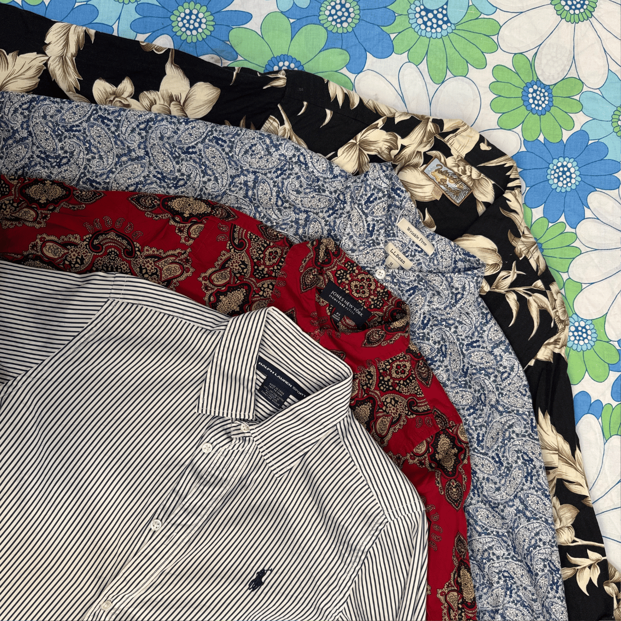 Folded shirts on a floral-patterned surface