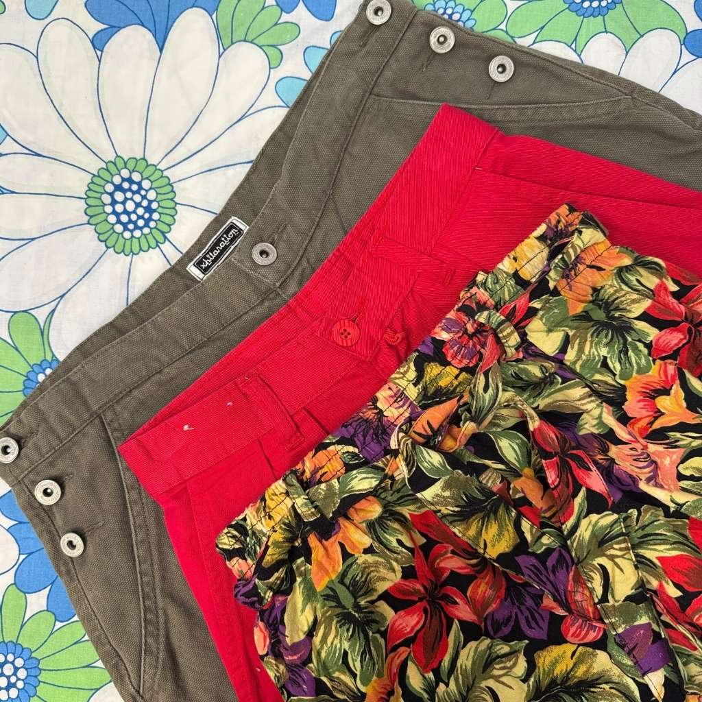 three pairs of shorts with a floral pattern on a colorful floral background