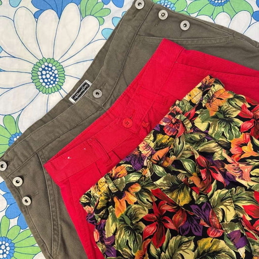 three pairs of shorts with a floral pattern on a colorful floral background