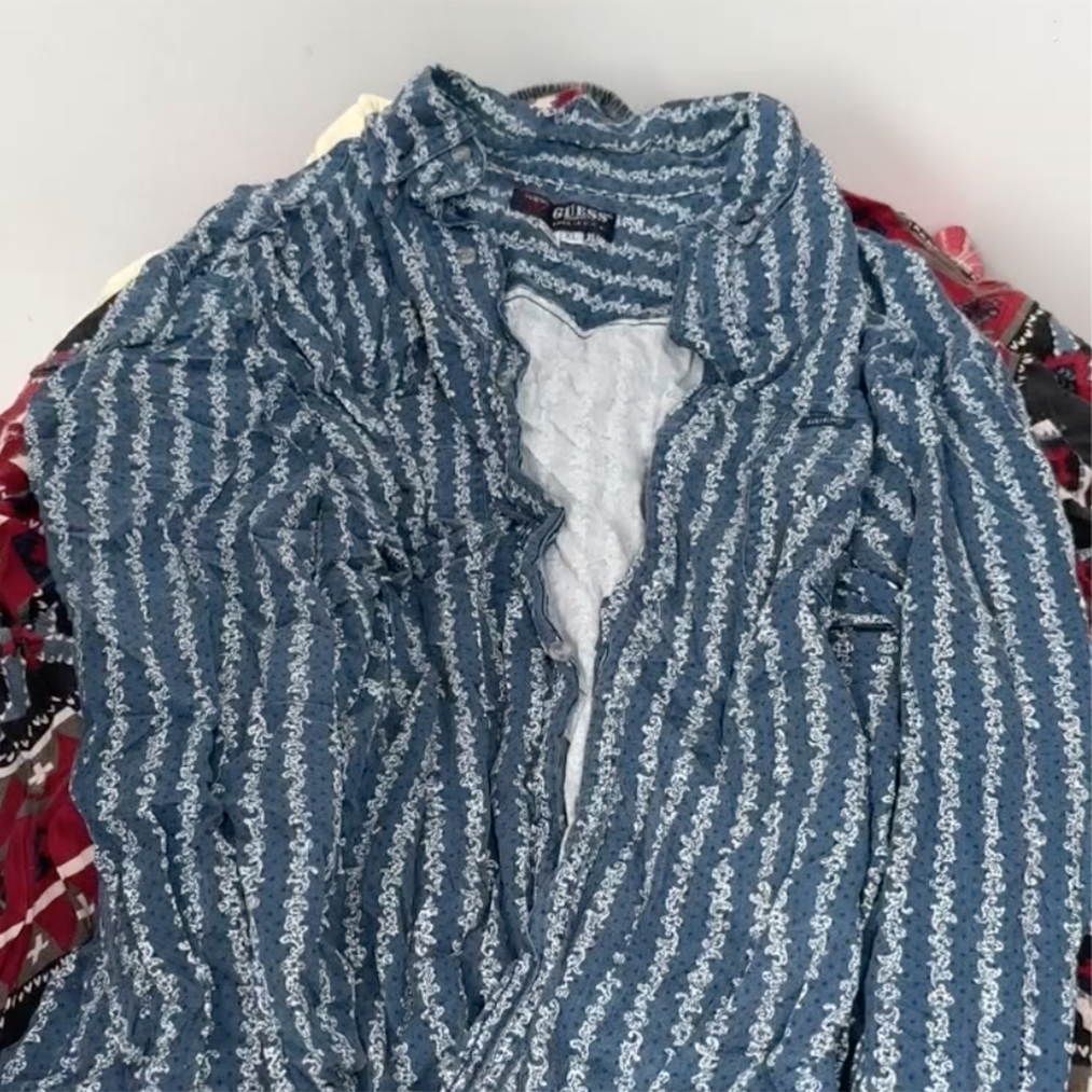 Unboxing video of men’s vintage denim shirts bale showing a mix of branded styles from Levi’s, Wrangler, Tommy Hilfiger, Columbia, and more – wholesale vintage for resellers.