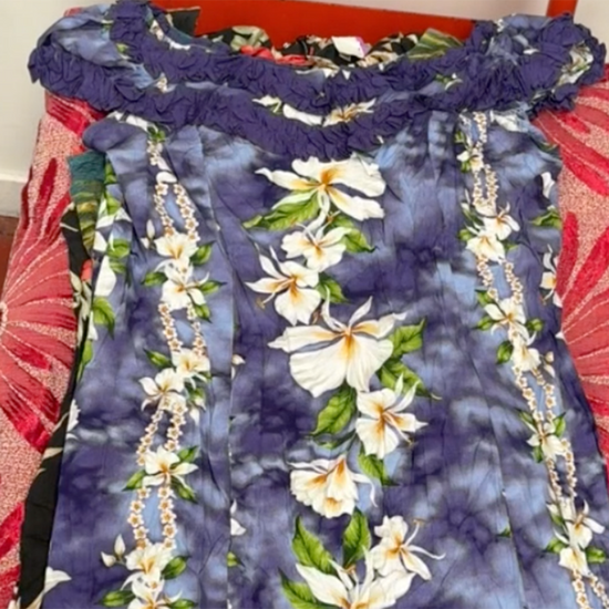 Unboxing a 45kg wholesale bale of vintage Hawaiian dresses for women – assorted tropical prints, summer styles, and bold colours.