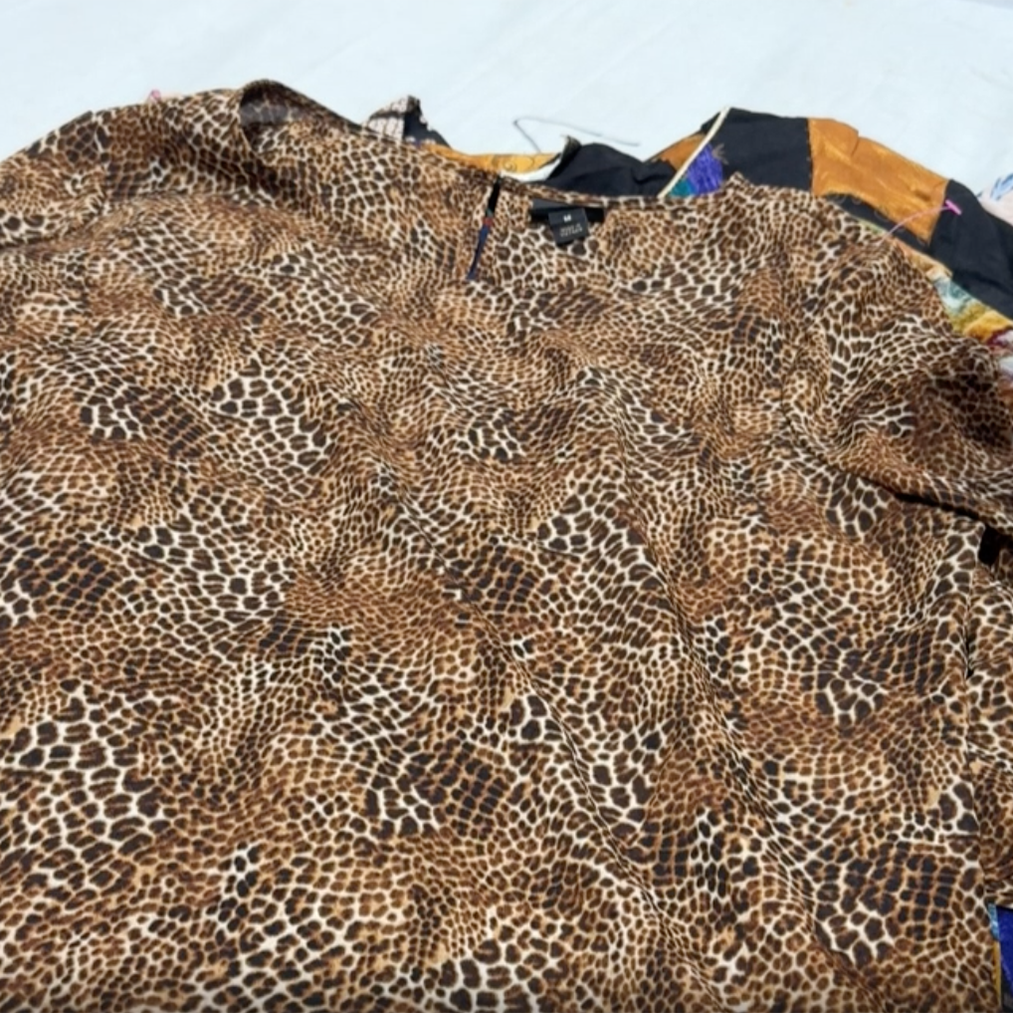 Unboxing a wholesale bale of women’s vintage long and short sleeve tops – assorted styles, fabrics, and colours for resale