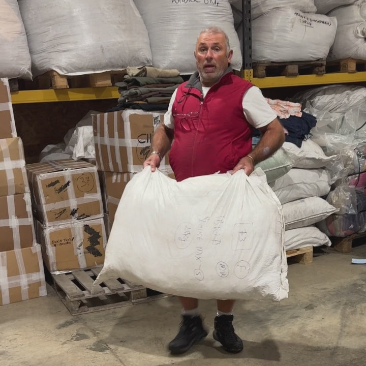 Unboxing a wholesale bale of women’s vintage long and short sleeve tops – assorted styles, fabrics, and colours for resale